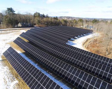 High-resolution solar panels installed on a large solar farm amid snowy terrain, representing renewable energy solutions.